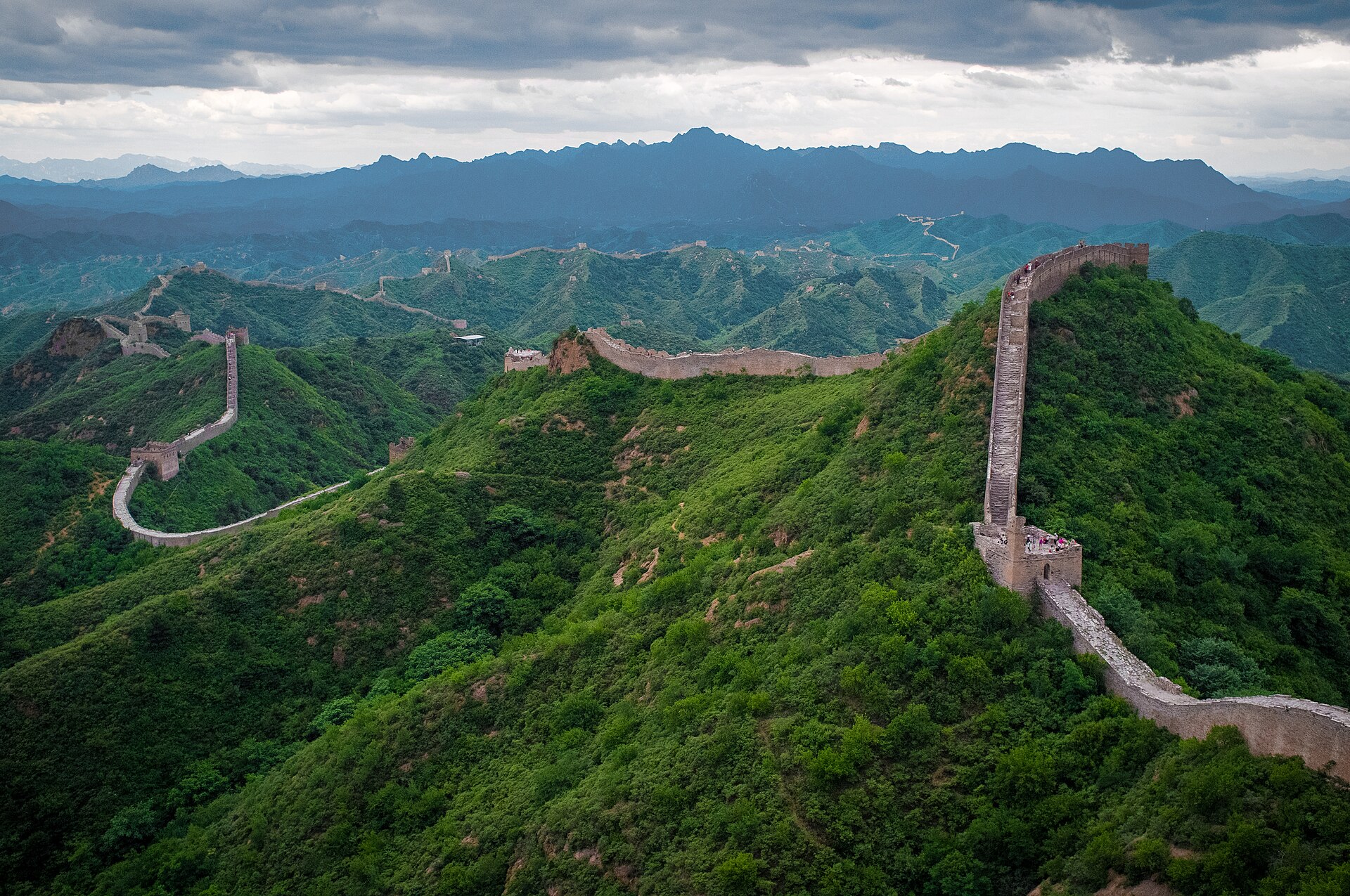 The Great Wall crossing green forested ridges at Jinshanling, northeast of Beijing