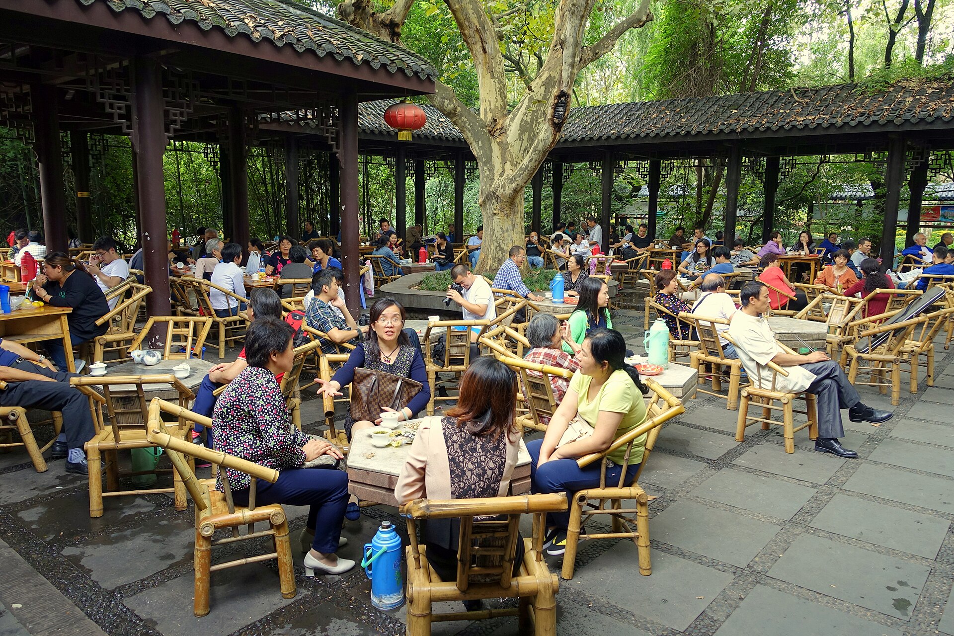 Bamboo chairs and covered tea bowls fill the open-air teahouse in Chengdu's People's Park