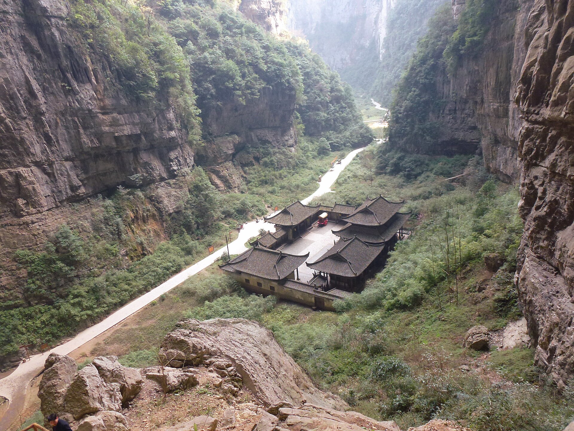 The sinkhole courtyard and Tianfu post house below the Three Natural Bridges at Wulong