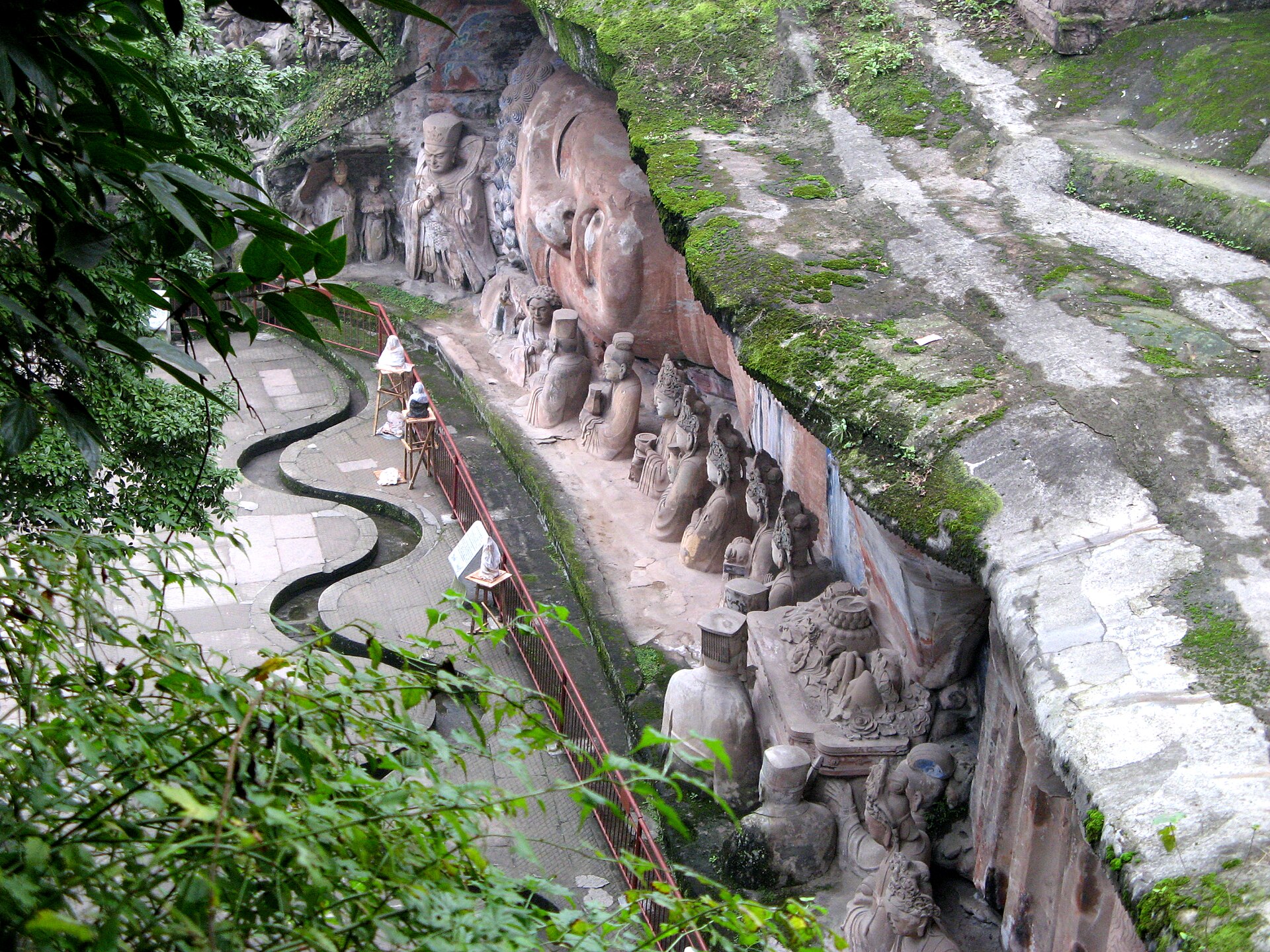 The reclining Buddha and its row of attendant figures carved into the cliff at Baodingshan, Dazu