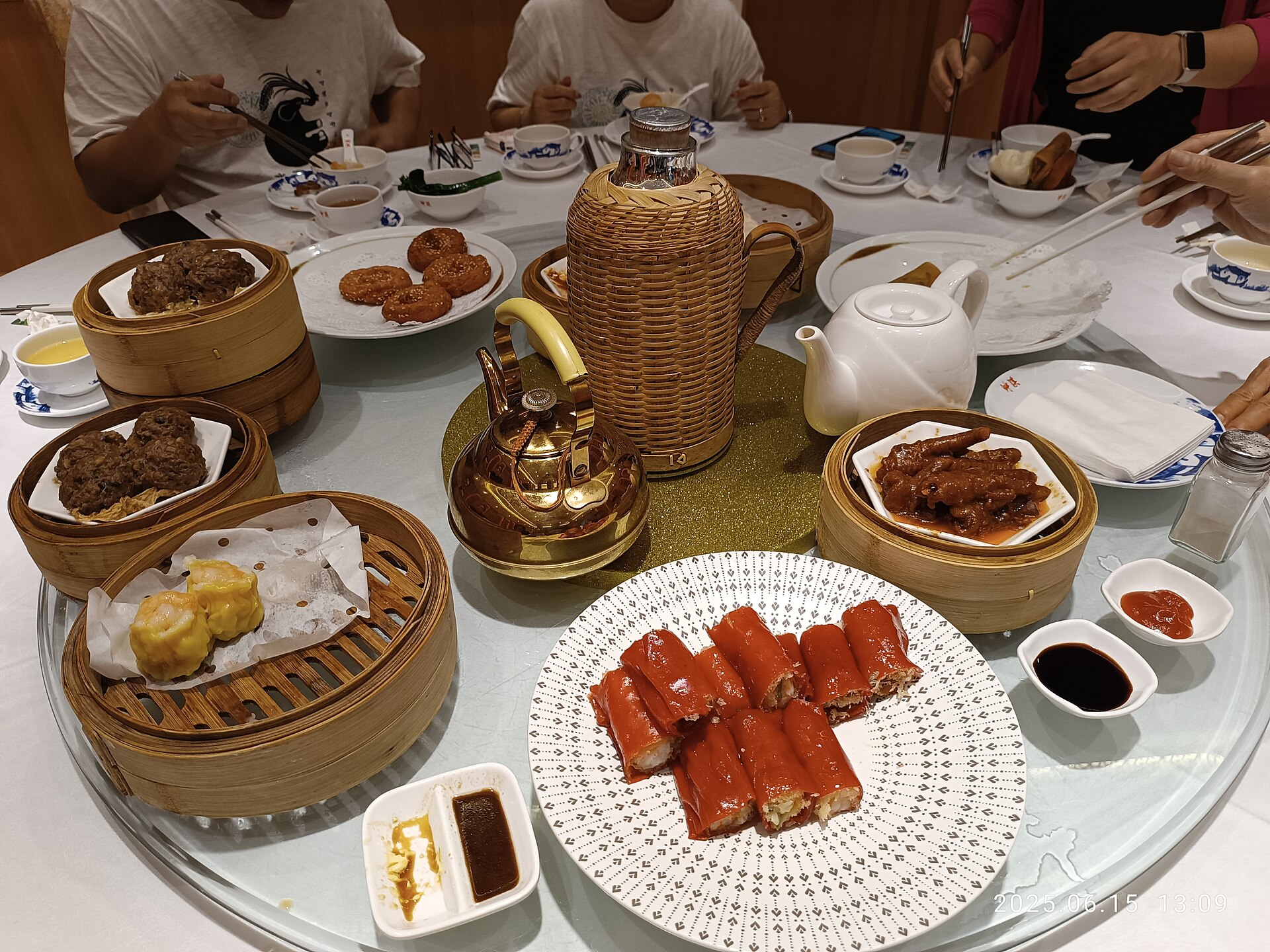 A yum cha table in Liwan, Guangzhou: red rice rolls, siu mai, beef balls and chicken feet around the tea kettle