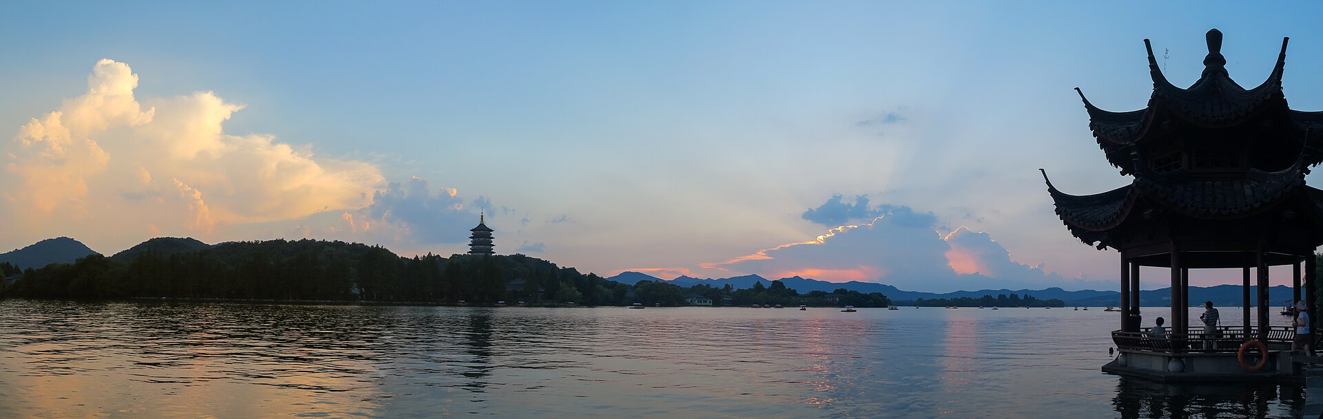 Leifeng Pagoda across West Lake at dusk, seen from beside the Jixian Pavilion on the east shore