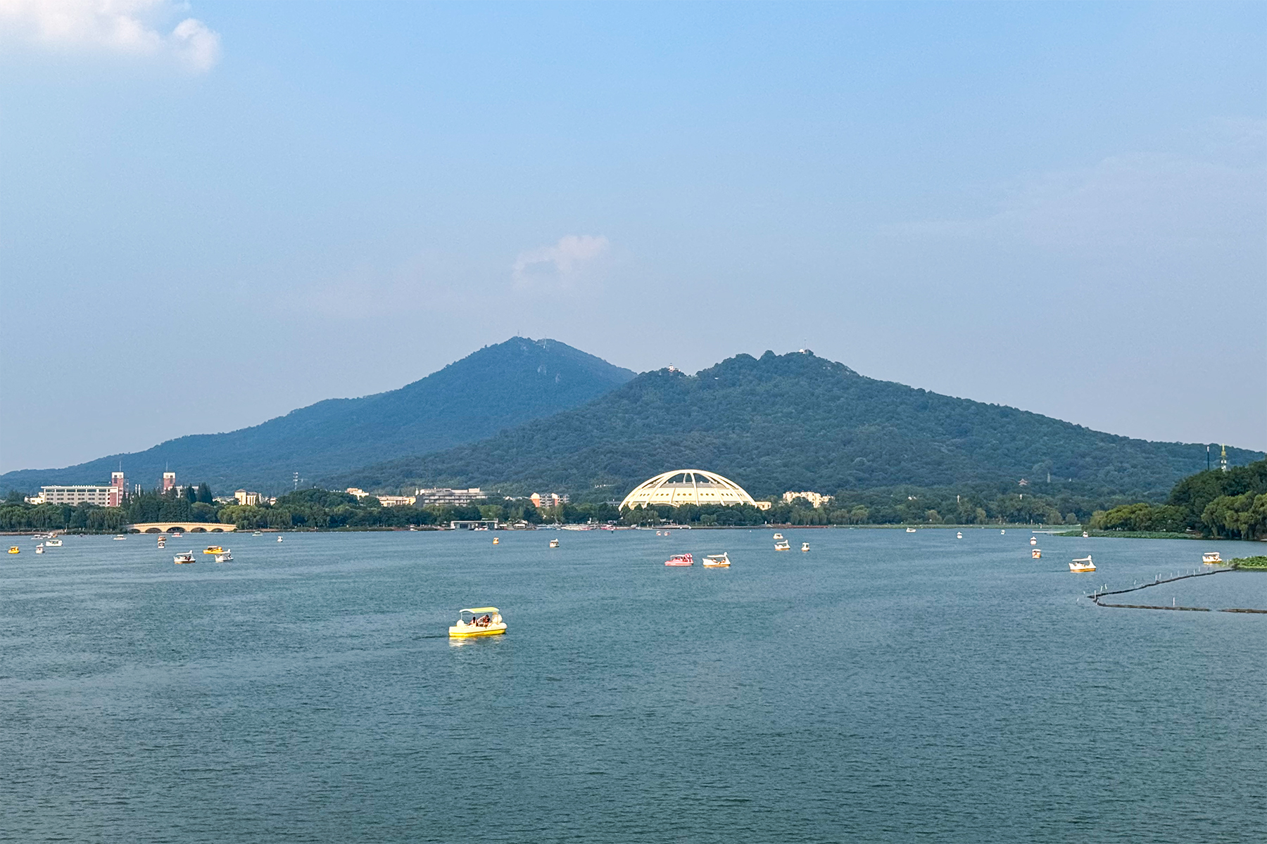 Xuanwu Lake with pleasure boats, Purple Mountain rising green behind the far shore