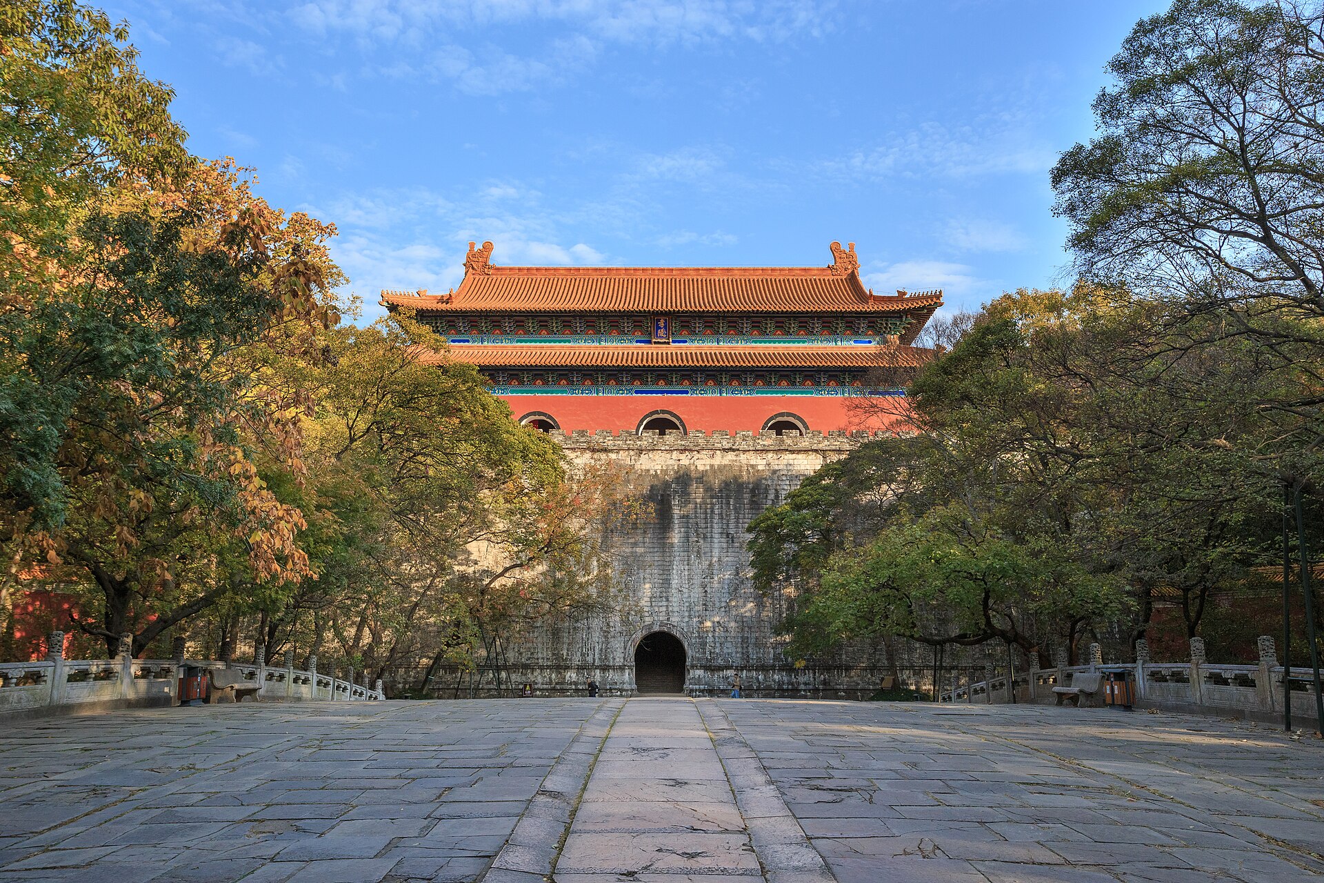 The Ming Tower of the Ming Xiaoling Mausoleum above its stone terrace, framed by autumn trees at Purple Mountain