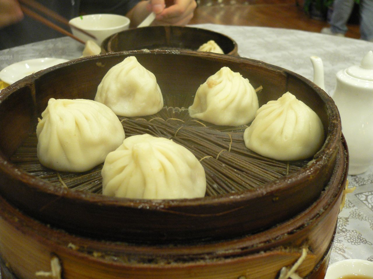 Crab xiaolongbao in a bamboo steamer on a restaurant table in Nanxiang, Shanghai