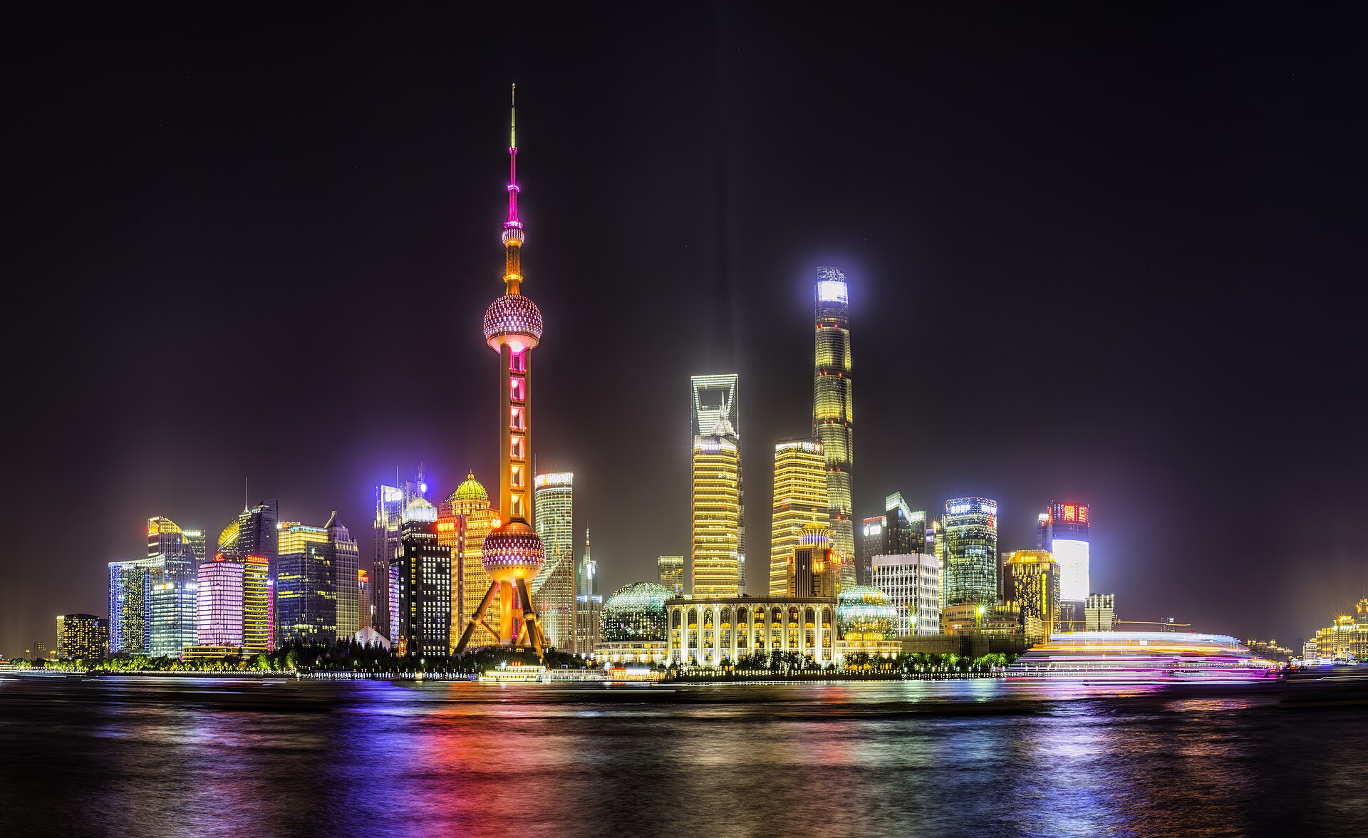 The Pudong skyline and Oriental Pearl Tower across the Huangpu River at night, seen from the Bund