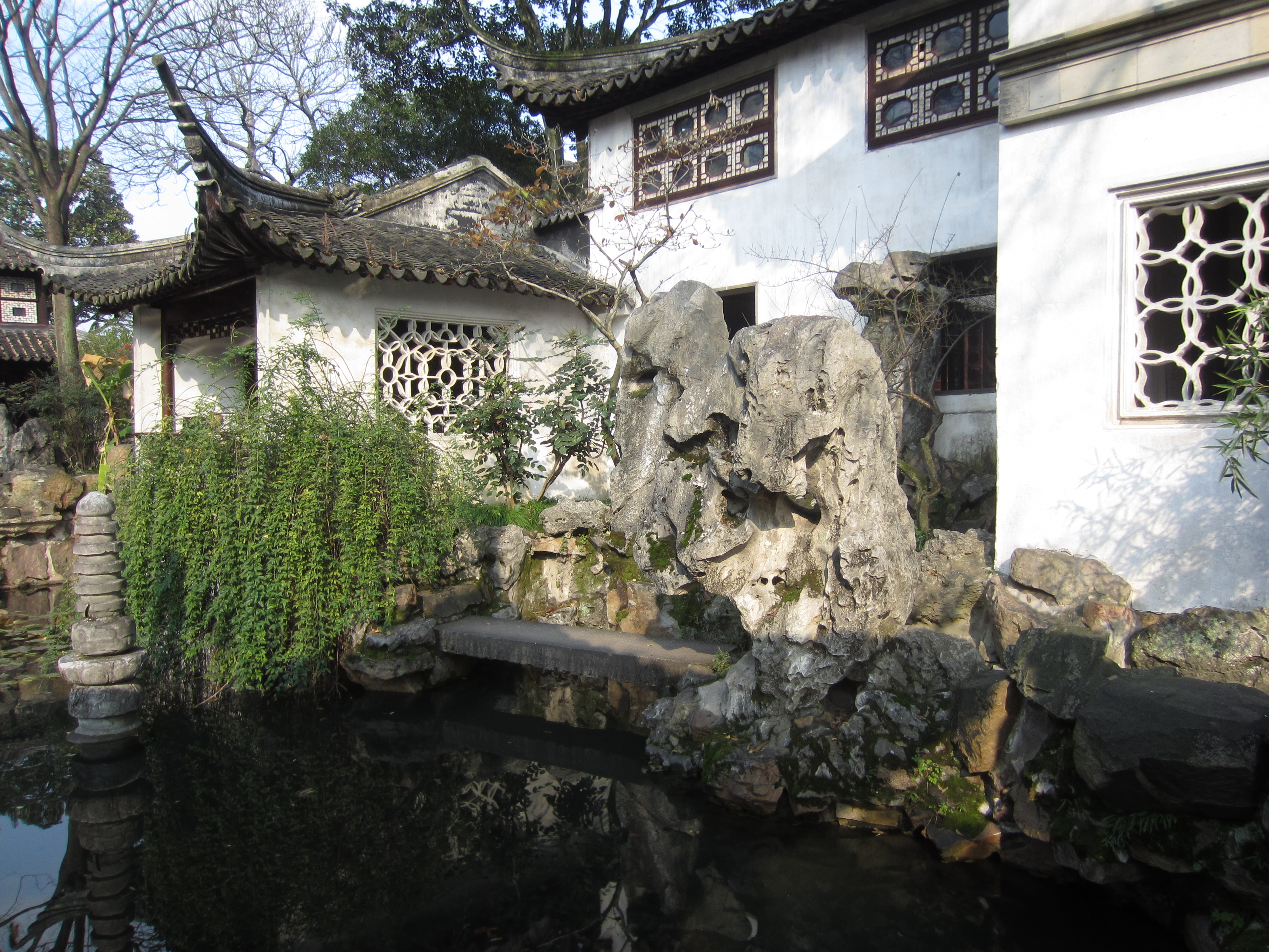 White walls, lattice windows and a taihu rockery above the water at the Lingering Garden, Suzhou