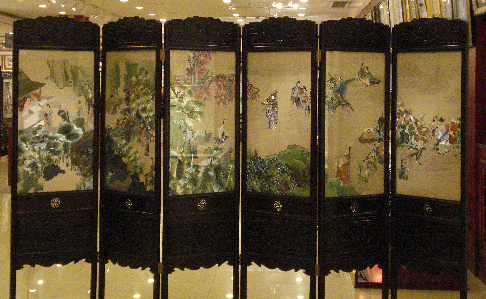 A six-panel folding screen of Suzhou embroidery, landscape scenes stitched in silk thread