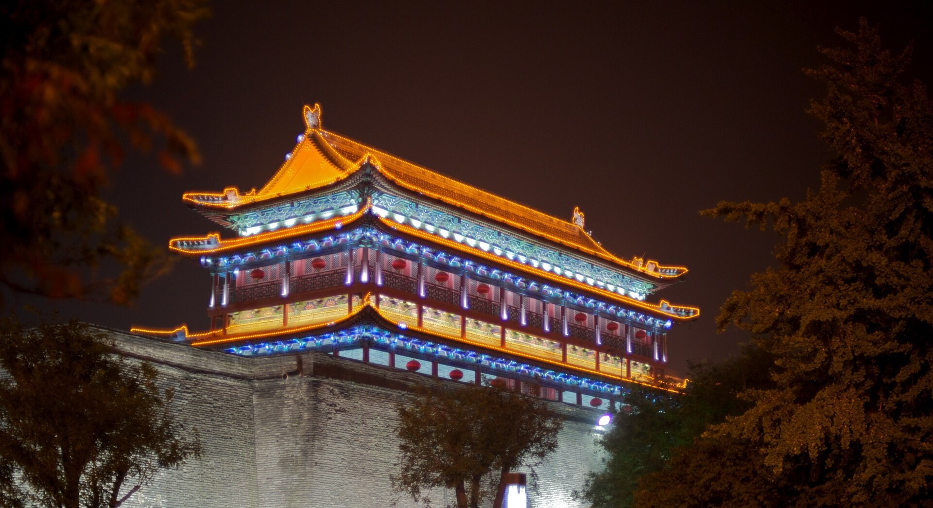 Xi'an's illuminated city wall and gate tower at dusk